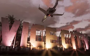 Plane flying over the Vice City sign at sunset